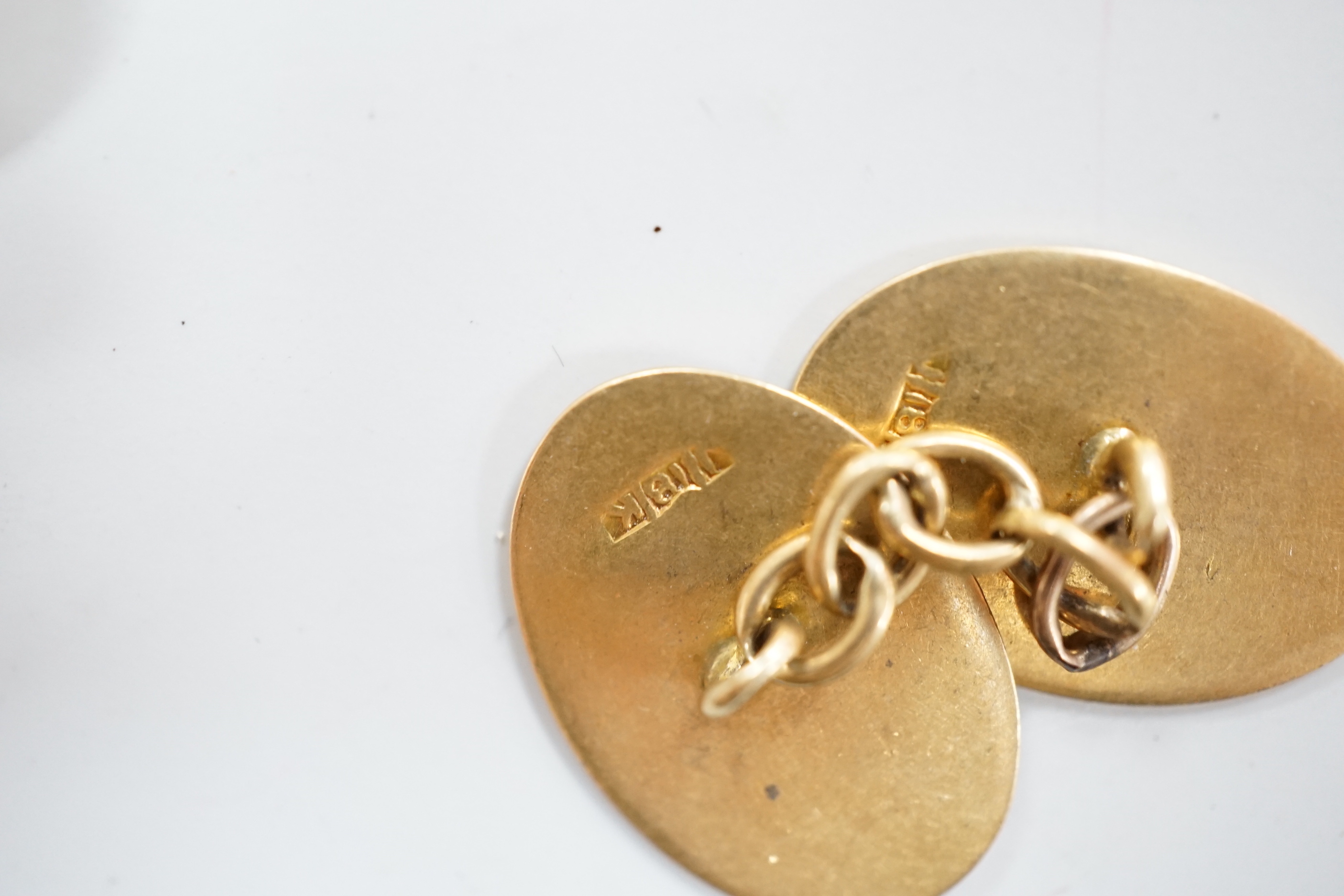 A pair of 18ct gold rectangular cufflinks, with enamelled initial N, 8.2 grams, and a pair of 18ct gold monogrammed oval cufflinks, 8 grams